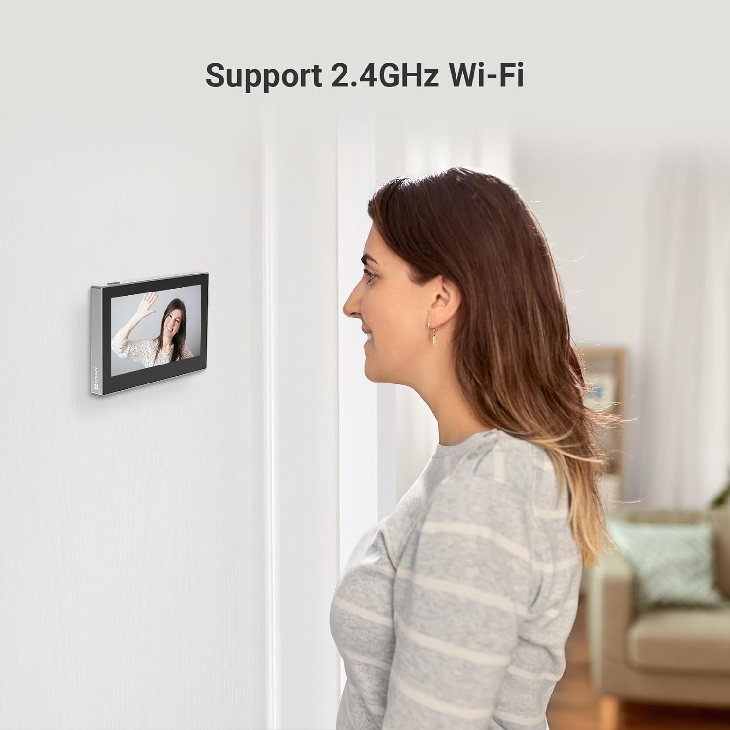 Woman looking at a digital photo frame on a wall with text 'Support 2.4GHz Wi-Fi'.